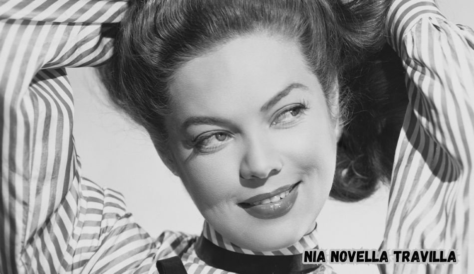 Nia Novella Travilla smiling at a public event