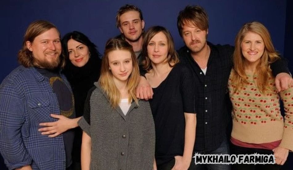 Mykhailo Farmiga smiling at an event in a formal suit
