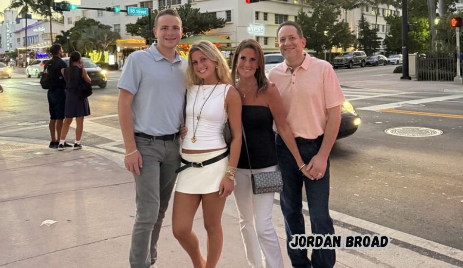 Jordan Broad smiling outdoors in casual attire