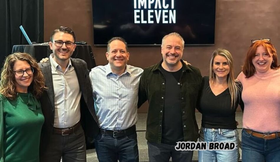 Jordan Broad smiling outdoors in casual attire